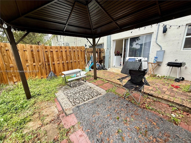 view of yard featuring fence, a gazebo, and a patio