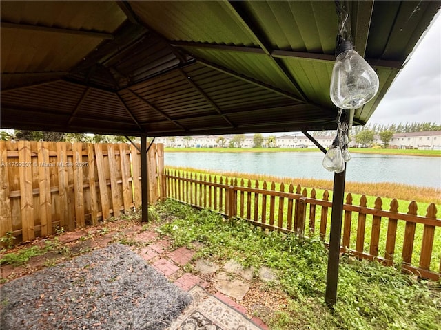 exterior space featuring a water view and fence