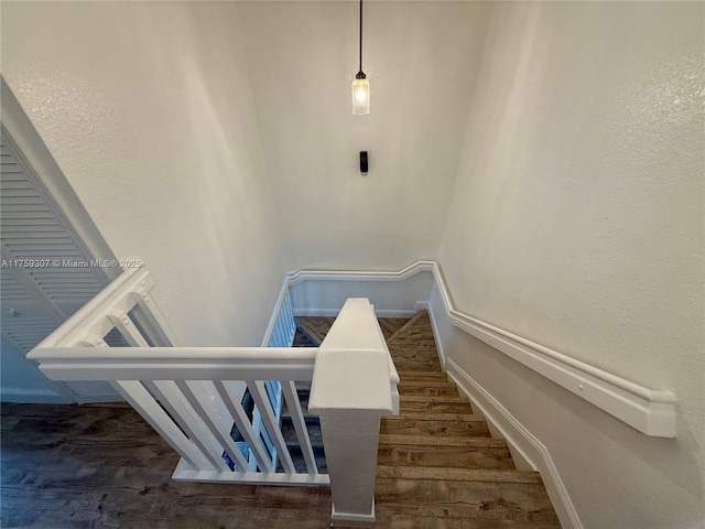 stairs featuring baseboards and wood finished floors