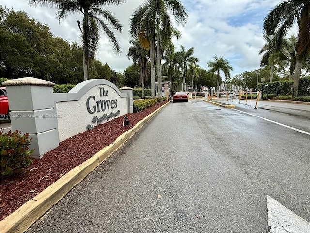 view of street with curbs and a gated entry