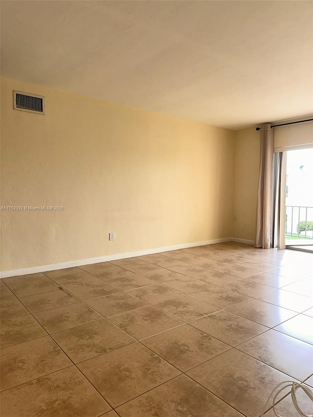 tiled spare room with baseboards and visible vents