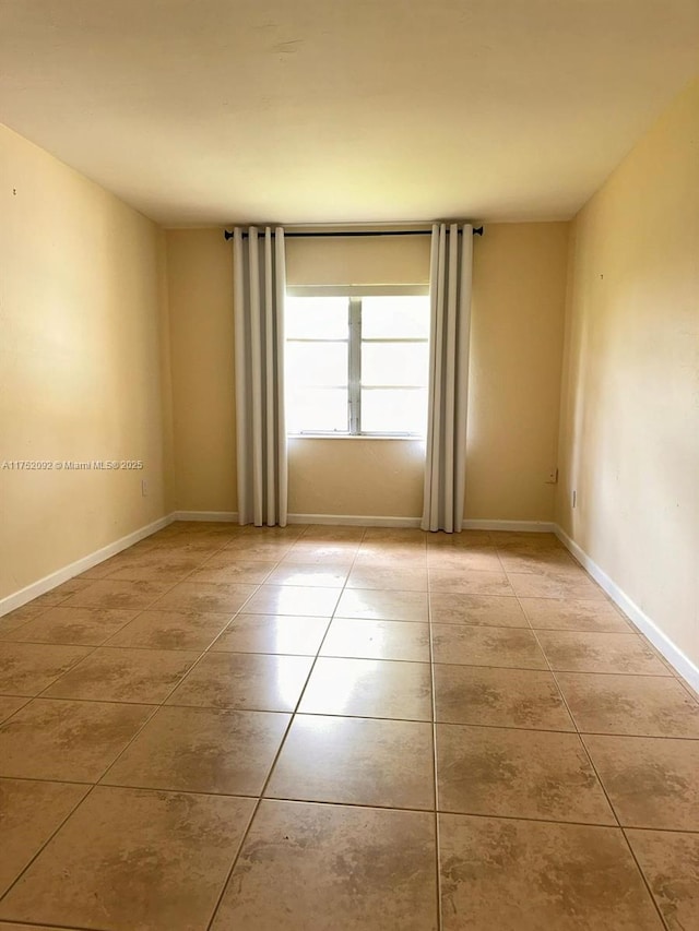 tiled spare room with baseboards