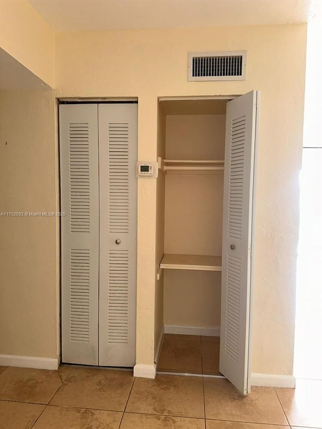 closet with a heating unit and visible vents