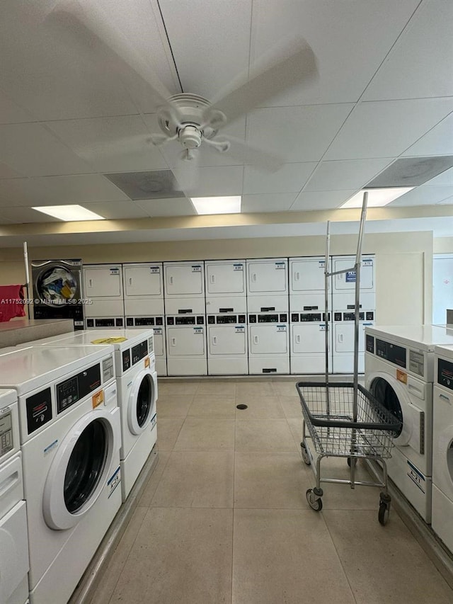 community laundry room featuring stacked washing maching and dryer, washing machine and dryer, and a ceiling fan