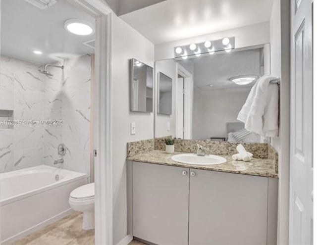 bathroom with toilet, shower / washtub combination, and vanity