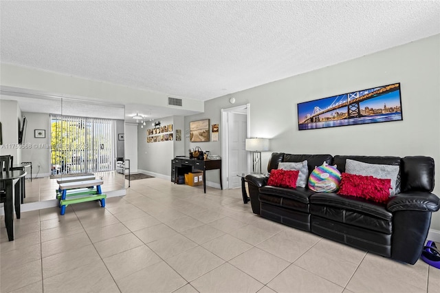 tiled living area with baseboards, visible vents, and a textured ceiling