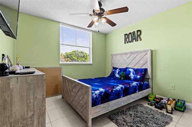 tiled bedroom featuring ceiling fan and a textured ceiling