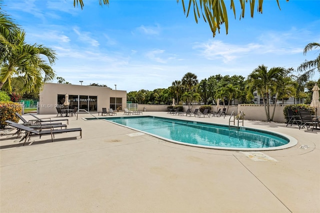 pool featuring a patio area and fence