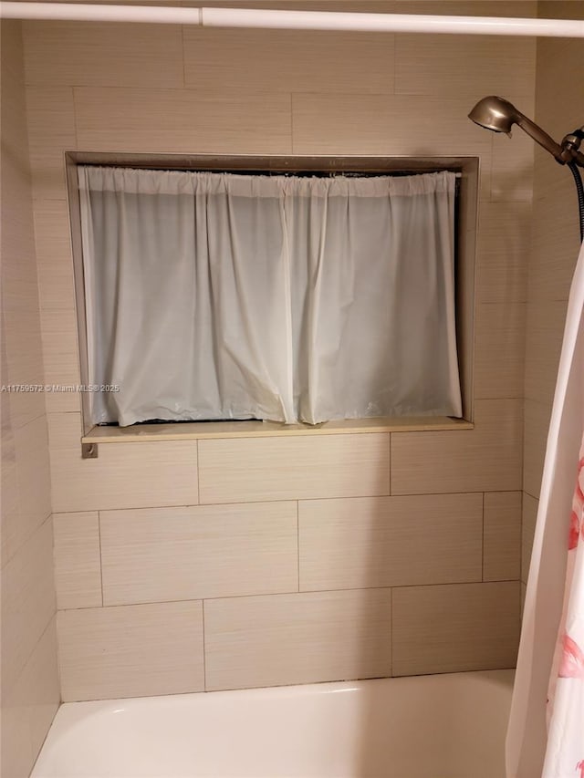 bathroom with shower / bathtub combination with curtain