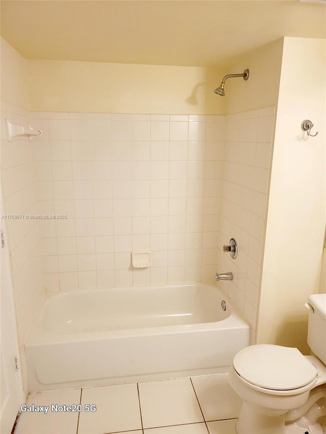 bathroom featuring toilet, bathing tub / shower combination, and tile patterned flooring