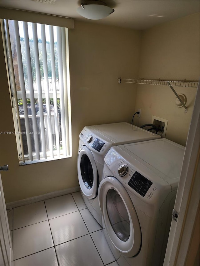 washroom with tile patterned flooring, laundry area, independent washer and dryer, and plenty of natural light