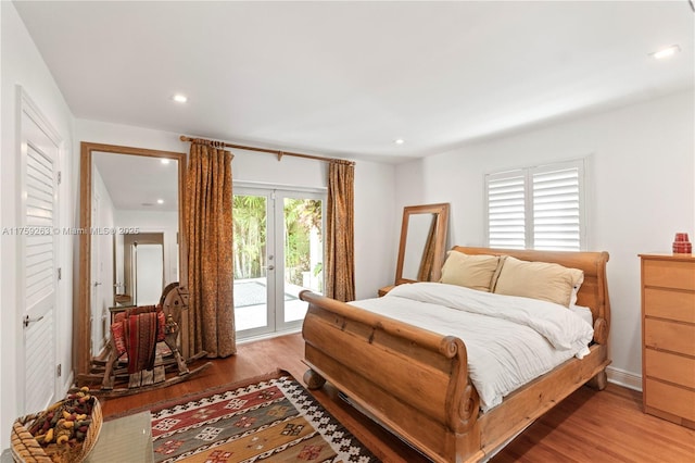 bedroom featuring access to outside, wood finished floors, and recessed lighting