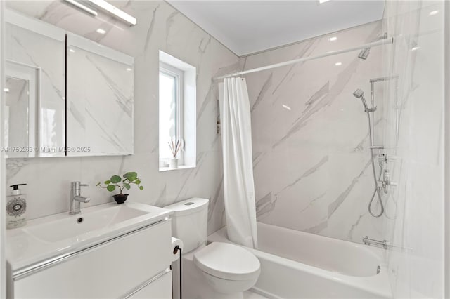 full bathroom featuring toilet, shower / bath combo with shower curtain, tile walls, and vanity