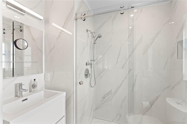 full bathroom with a marble finish shower and vanity