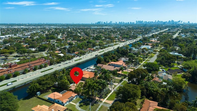 birds eye view of property with a water view and a view of city