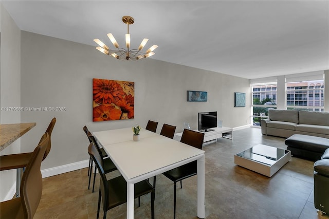 dining room with baseboards and a notable chandelier