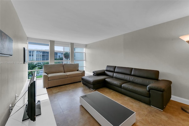 living room with baseboards and floor to ceiling windows