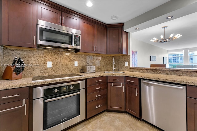 kitchen with light tile patterned floors, tasteful backsplash, an inviting chandelier, stainless steel appliances, and a sink