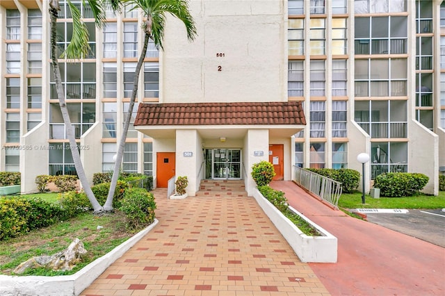 view of building exterior featuring uncovered parking