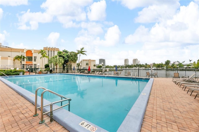 community pool featuring a patio area and fence