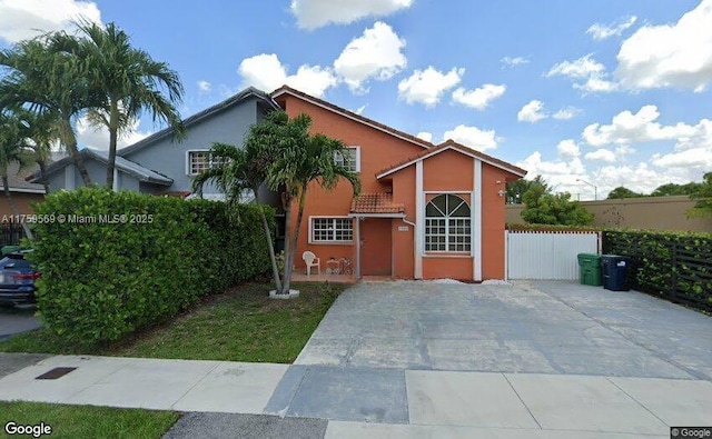 7801 SW 9th Ter, Miami, FL 33144 - traditional-style house featuring fence, stucco siding, and a tiled roof