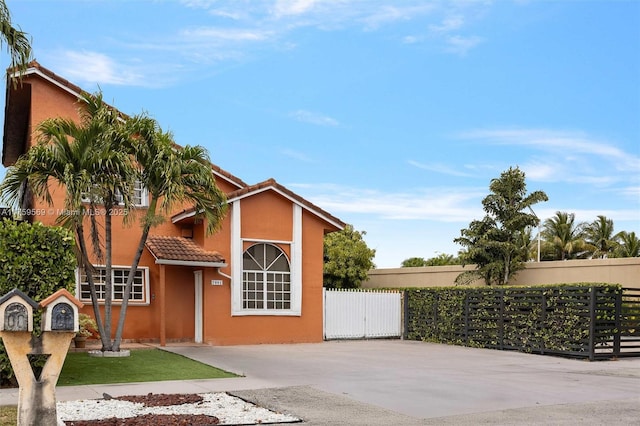 7801 SW 9th Ter, Miami, FL 33144 - view of front of home featuring a tile roof, stucco siding, and fence