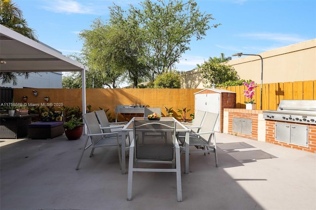 7801 SW 9th Ter, Miami, FL 33144 - view of patio featuring outdoor dining space, area for grilling, a fenced backyard, and exterior kitchen
