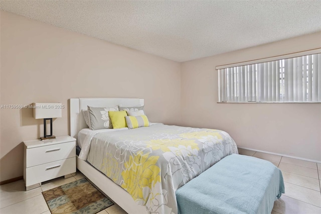 7801 SW 9th Ter, Miami, FL 33144 - bedroom featuring baseboards, light tile patterned floors, and a textured ceiling