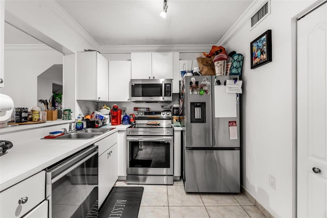 kitchen with crown molding, light countertops, visible vents, appliances with stainless steel finishes, and a sink