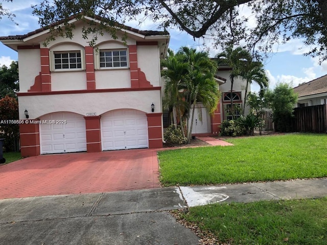 view of front of property with a garage, fence, decorative driveway, stucco siding, and a front lawn