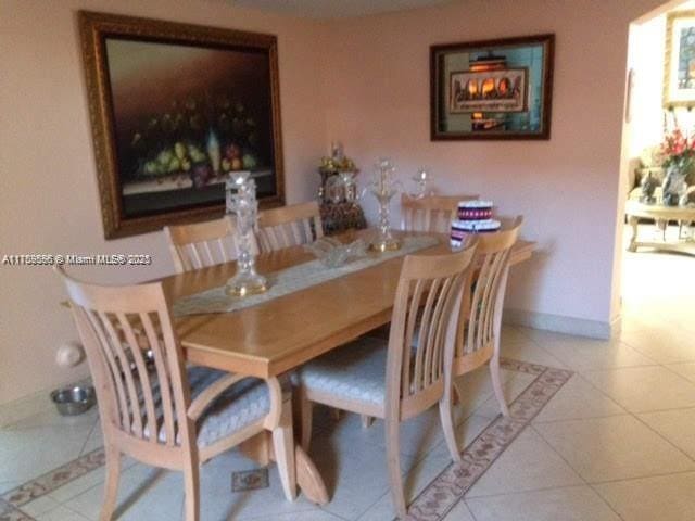 dining space with light tile patterned floors and baseboards