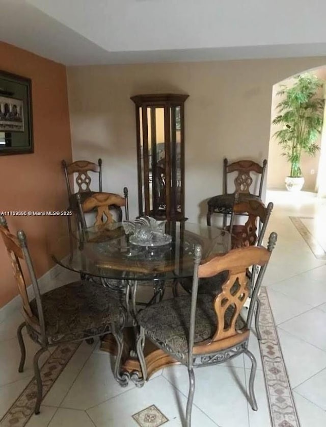 dining room with tile patterned flooring and baseboards