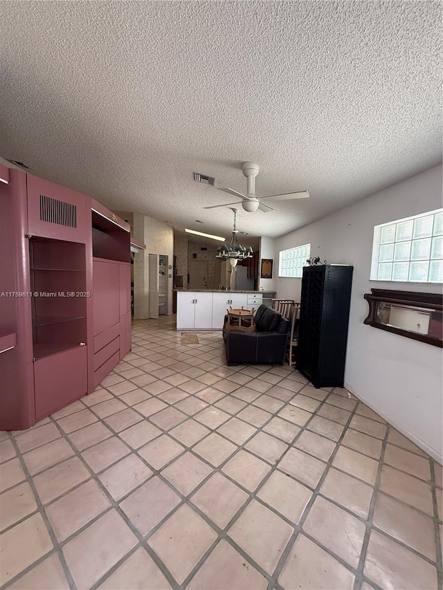 kitchen with ceiling fan, visible vents, and a textured ceiling