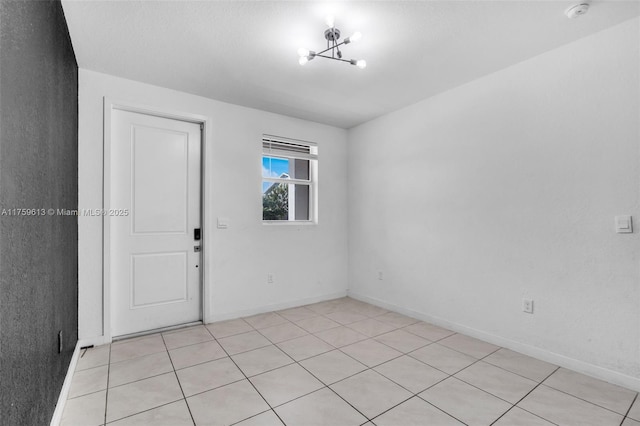 unfurnished room featuring baseboards