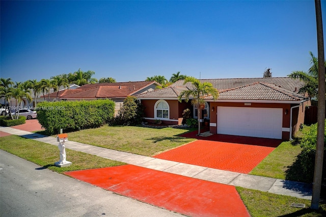 view of front of house with an attached garage, a tiled roof, a front lawn, and stucco siding