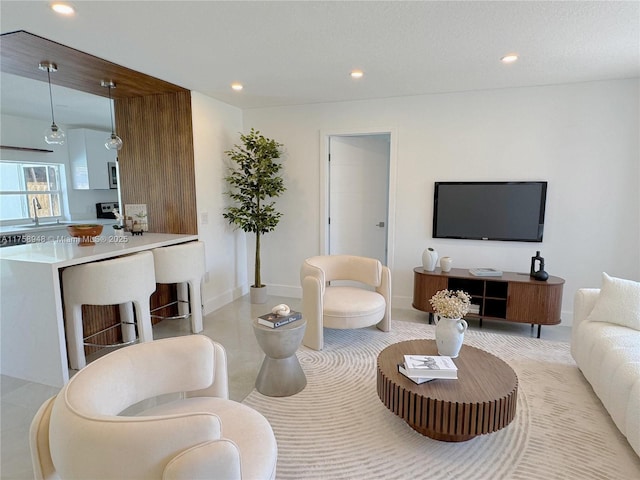 living room featuring recessed lighting and baseboards