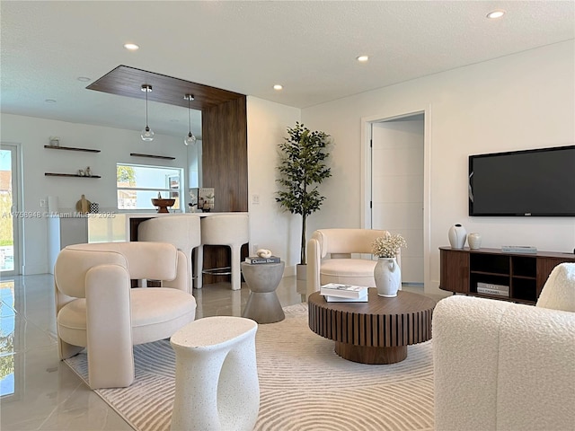 living area featuring recessed lighting and a textured ceiling