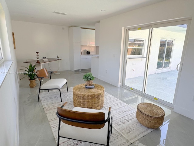 sitting room featuring baseboards and visible vents