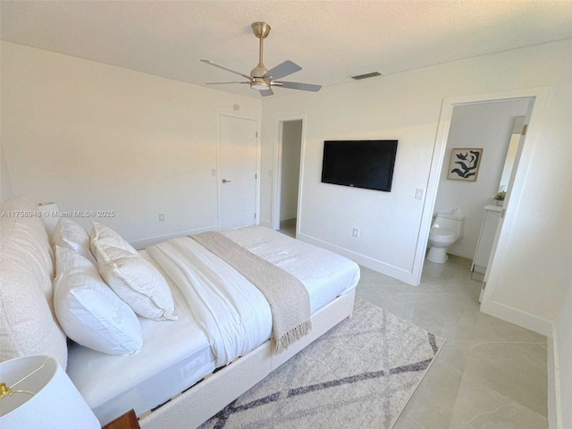 bedroom featuring a ceiling fan, baseboards, visible vents, ensuite bath, and marble finish floor