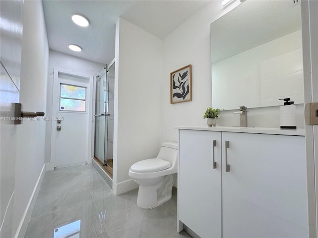 full bath with a shower stall, toilet, vanity, and baseboards