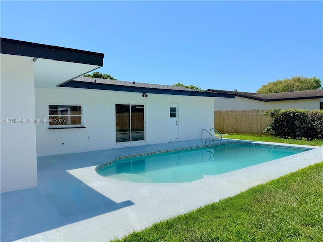 outdoor pool with a patio area and fence