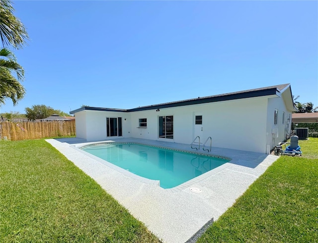 view of swimming pool with a yard, a fenced in pool, cooling unit, and fence