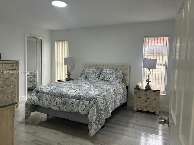 bedroom featuring baseboards and wood finished floors