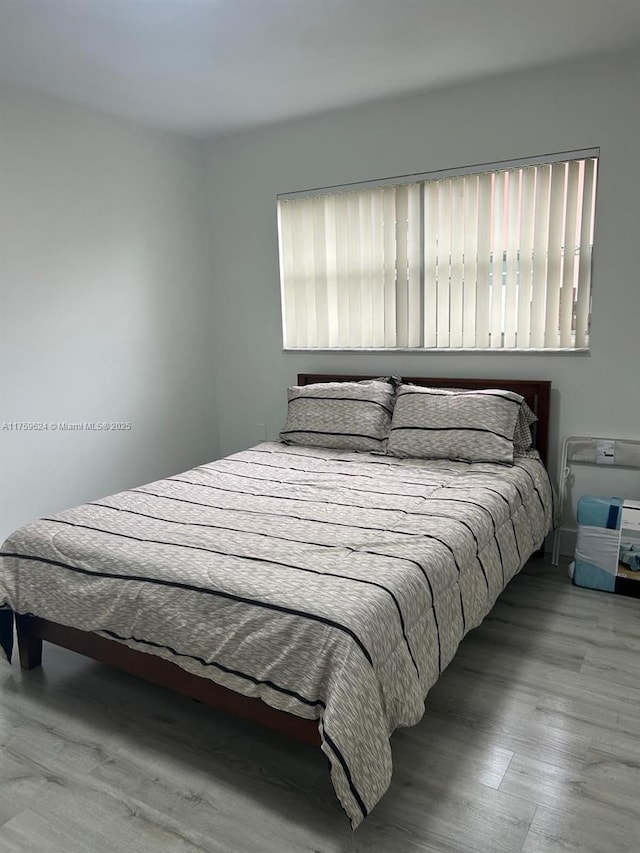 bedroom featuring wood finished floors