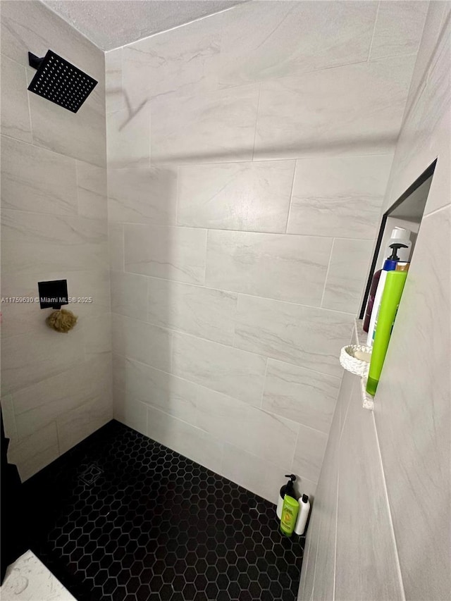 full bath featuring a tile shower