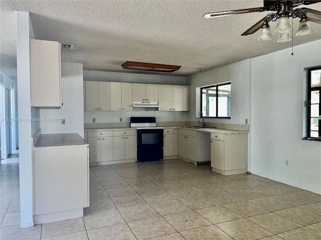 kitchen with visible vents, light countertops, electric range, a sink, and under cabinet range hood