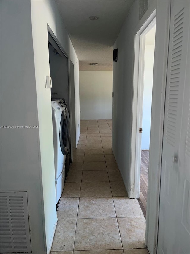 laundry area featuring light tile patterned floors, laundry area, washer / dryer, and visible vents