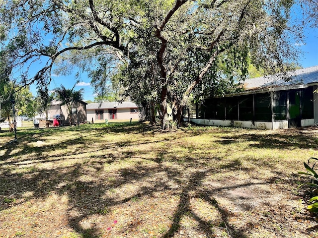 view of yard featuring a sunroom