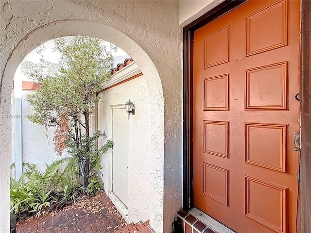 doorway to property with stucco siding