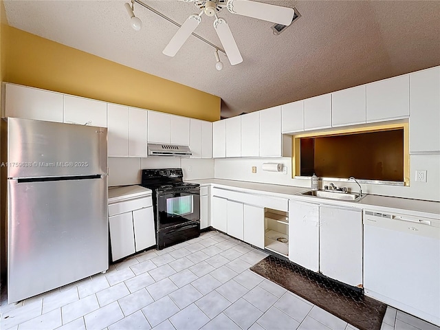 kitchen featuring under cabinet range hood, a sink, freestanding refrigerator, black / electric stove, and white dishwasher